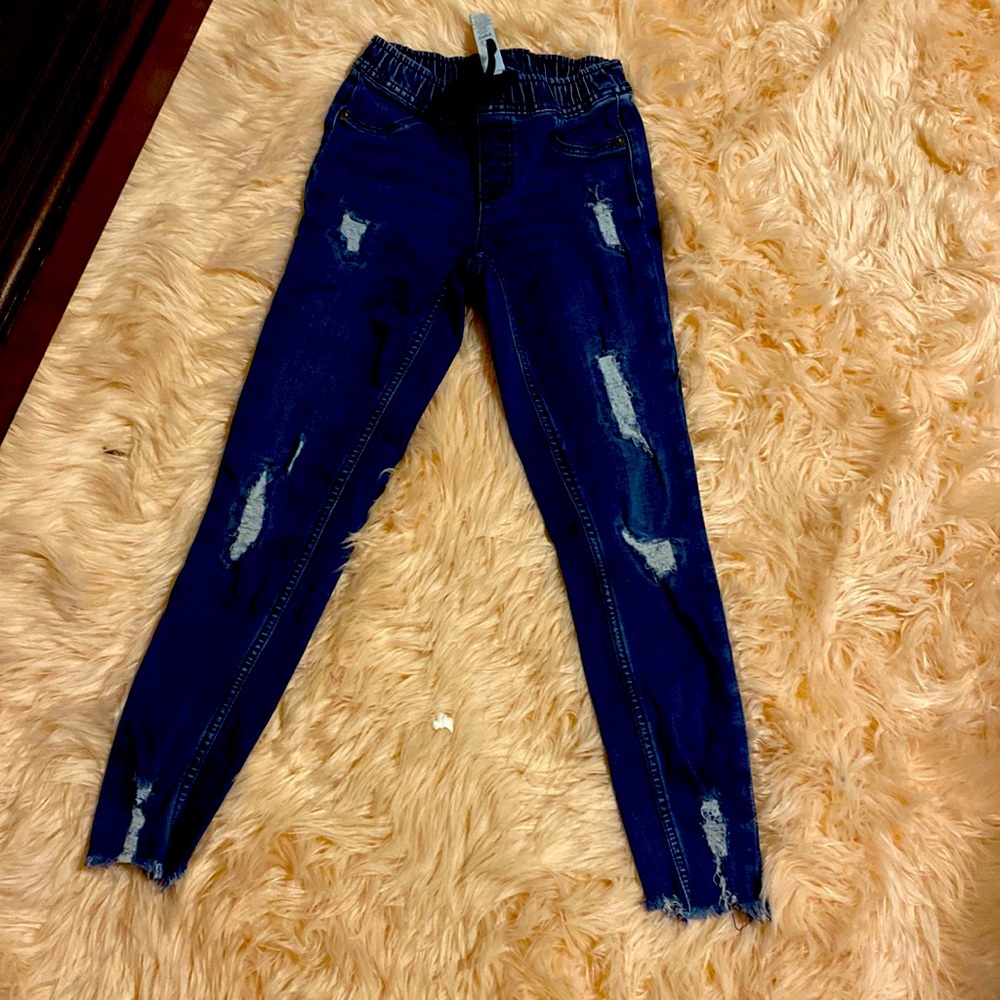 Denim dark blue elastic waist rips in front and back pockets fringe at bottom